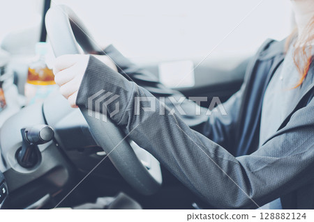 一名穿著防紫外線服裝開車的女子 一名穿著防紫外線服裝開車的女子 128882124