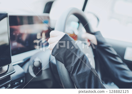 A woman driving wearing UV clothing 128882125