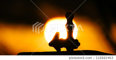 Silhouette of a drinking fountain in a park at dusk Silhouette of a drinking fountain in a park at dusk 128882463