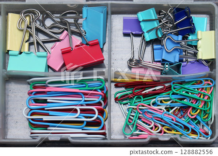 Paper and binder clips in box 128882556
