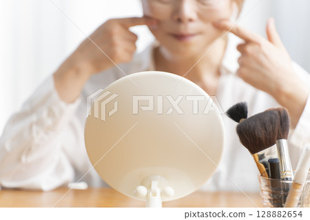 Senior woman concerned about facial aging Senior woman concerned about facial aging 128882654