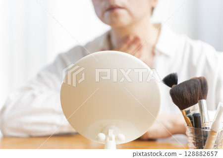 Senior woman concerned about facial aging Senior woman concerned about facial aging 128882657