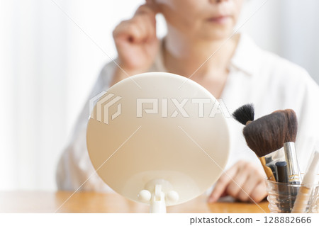 Senior woman concerned about facial aging Senior woman concerned about facial aging 128882666