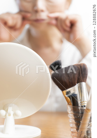 Senior woman concerned about facial aging 128882676