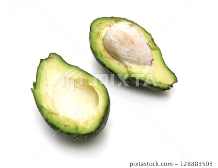 Avocado cut on white background Avocado cut on white background 128883503