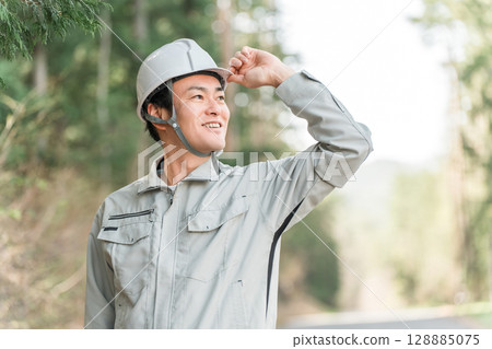 Forestry / Environmental protection / Men in work clothes at construction sites 128885075