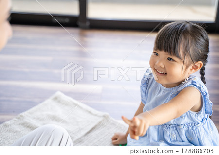 Parents and children enjoying a game of Rock-Paper-Scissors Parents and children enjoying a game of Rock-Paper-Scissors 128886703