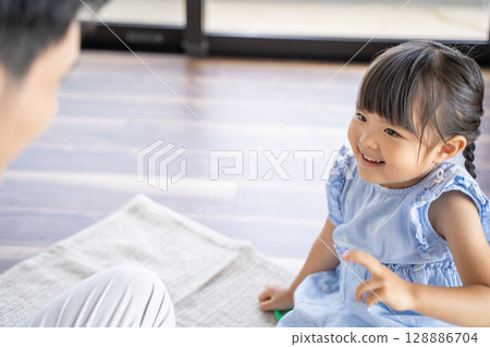 Parents and children enjoying a game of Rock-Paper-Scissors Parents and children enjoying a game of Rock-Paper-Scissors 128886704