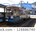 [Logo driver and passenger sign blurred] Hakodate City Tram No. 530 stopped at Jujigai Tram Stop 128886740