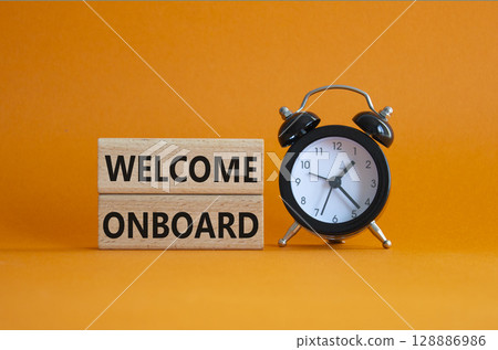 Welcome onboard symbol. Concept words Welcome onboard on wooden blocks. Beautiful green background with alarm clock. Business and Welcome onboard concept. Copy space. 128886986