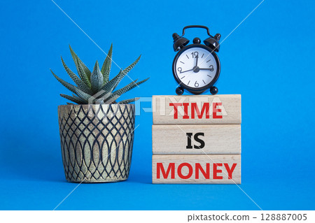 Time is Money symbol. Concept words Time is Money on wooden blocks. Beautiful blue background with alarm clock and succulent plant. Business and Time is Money concept. Copy space 128887005