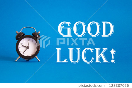 Good luck symbol. Beautiful blue background with alarm clock. Business and Good luck concept. Copy space. 128887026