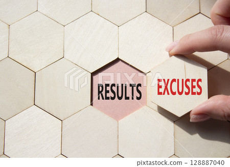 Results or Excuses symbol. Concept word Results or Excuses on wooden comb puzzle. Businessman hand. Beautiful pink background. Business and Results or Excuses concept. Copy space 128887040
