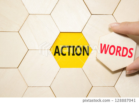 Action or words symbol. Concept word Action or words on wooden comb puzzle. Businessman hand. Beautiful yellow background. Business and Action or words concept. Copy space 128887041