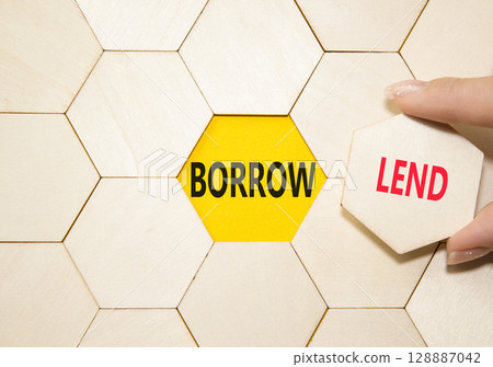 Lend or Borrow symbol. Concept word Lend or Borrow on wooden comb puzzle. Businessman hand. Beautiful yellow background. Business and Lend or Borrow concept. Copy space Lend or Borrow symbol. Concept word Lend or Borrow on wooden comb puzzle. Businessman hand. Beautiful yellow background. Business and Lend or Borrow concept. Copy space 128887042