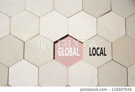 Global and Local symbol. Concept word Global and Local on wooden comb puzzle. Beautiful pink background. Business and Global and Local concept. Copy space Global and Local symbol. Concept word Global and Local on wooden comb puzzle. Beautiful pink background. Business and Global and Local concept. Copy space 128887048