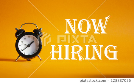 Now Hiring symbol. Concept word Now Hiring on Beautiful orange background with alarm clock. Business and Now Hiring concept. Copy space Now Hiring symbol. Concept word Now Hiring on Beautiful orange background with alarm clock. Business and Now Hiring concept. Copy space 128887056
