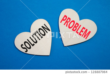 Solution vs Problem symbol. Concept word Solution vs Problem on wooden hearts. Beautiful blue background. Business and Solution vs Problem concept. Copy space 128887064