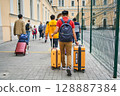 June 12, 2023 Saint Petersburg . Tourists walking with luggage toward city 128887384
