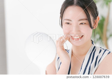 Young woman having a dental check Young woman having a dental check 128887639