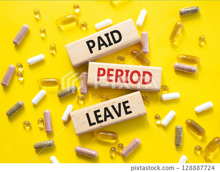 Paid Period Leave symbol. Concept words Paid Period Leave on wooden blocks. Beautiful yellow background with pills. Healthcare and Paid Period Leave concept. Copy space. Paid Period Leave symbol. Concept words Paid Period Leave on wooden blocks. Beautiful yellow background with pills. Healthcare and Paid Period Leave concept. Copy space. 128887724