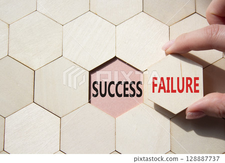 Success or Failure symbol. Concept word Success or Failure on wooden comb puzzle. Businessman hand. Beautiful pink background. Business and Success or Failure concept. Copy space 128887737