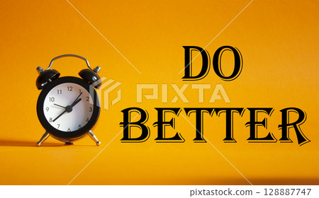 Do better symbol. Beautiful orange background with alarm clock. Business and Do better concept. Copy space. 128887747