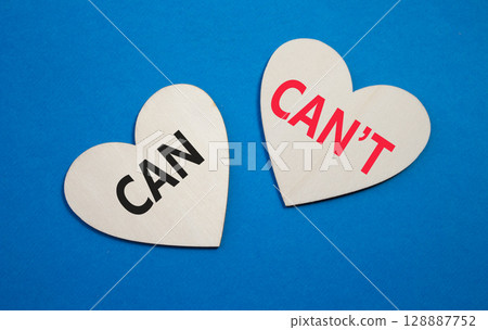 Can or Cant symbol. Concept word Can or Cant on wooden hearts. Beautiful blue background. Business and Can or Cant concept. Copy space 128887752
