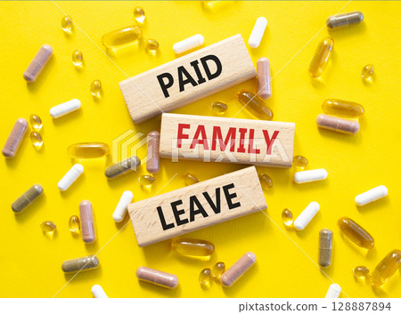 Paid Family Leave symbol. Concept words Paid Family Leave on wooden blocks. Beautiful yellow background with pills. Healthcare and Paid Family Leave concept. Copy space. Paid Family Leave symbol. Concept words Paid Family Leave on wooden blocks. Beautiful yellow background with pills. Healthcare and Paid Family Leave concept. Copy space. 128887894