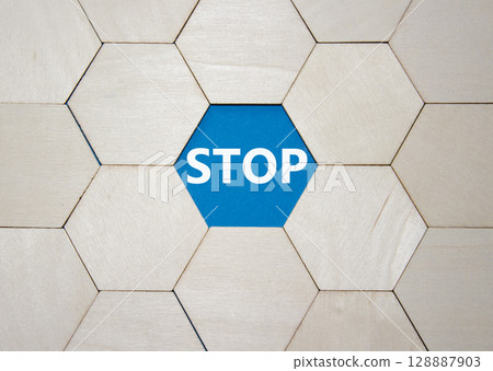 Stop symbol. Concept word Stop on wooden comb puzzle. Beautiful blue background. Business and Stop concept. Copy space. 128887903