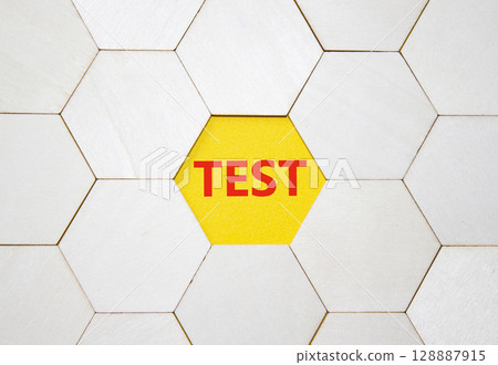 Test symbol. Concept word Test on wooden comb puzzle. Beautiful yellow background. Business and Test concept. Copy space. 128887915