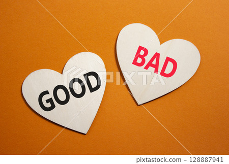 Good or Bad symbol. Concept word Good or Bad on wooden hearts. Beautiful orange background. Business and Good or Bad concept. Copy space 128887941