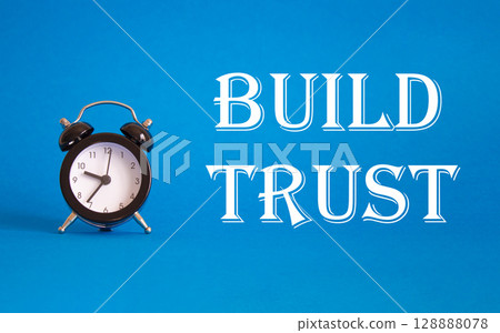 Build trust symbol. Beautiful blue background with alarm clock. Business and Build trust concept. Copy space. Build trust symbol. Beautiful blue background with alarm clock. Business and Build trust concept. Copy space. 128888078