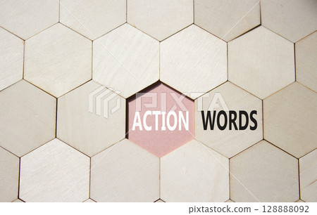 Action or words symbol. Concept word Action or words on wooden comb puzzle. Beautiful pink background. Business and Action or words concept. Copy space 128888092