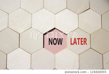 Now vs Later symbol. Concept word Now vs Later on wooden comb puzzle. Beautiful pink background. Business and Now vs Later concept. Copy space Now vs Later symbol. Concept word Now vs Later on wooden comb puzzle. Beautiful pink background. Business and Now vs Later concept. Copy space 128888093