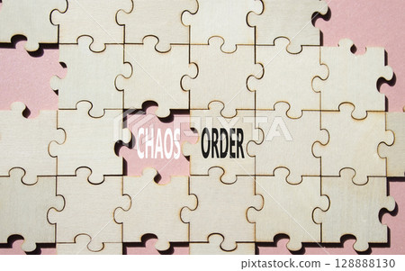 Chaos or Order symbol. Concept word Chaos or Order on wooden puzzle. Beautiful pink background. Business and Chaos or Order concept. Copy space Chaos or Order symbol. Concept word Chaos or Order on wooden puzzle. Beautiful pink background. Business and Chaos or Order concept. Copy space 128888130