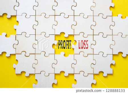 Profit or Loss symbol. Concept word Profit or Loss on wooden puzzle. Beautiful yellow background. Business and Profit or Loss concept. Copy space 128888133
