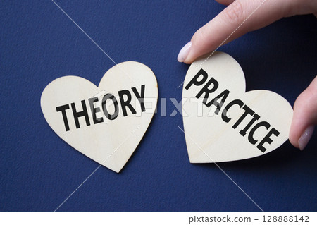Theory or Practice symbol. Concept word Theory or Practice on wooden hearts. Businessman hand. Beautiful deep blue background. Business and Theory or Practice concept. Copy space 128888142