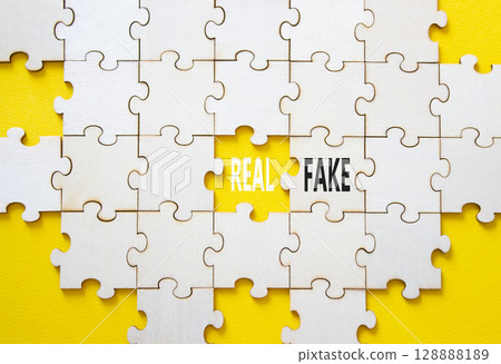 Real or Fake symbol. Concept word Real or Fake on wooden blocks. Beautiful yellow background. Business and Real or Fake concept. Copy space Real or Fake symbol. Concept word Real or Fake on wooden blocks. Beautiful yellow background. Business and Real or Fake concept. Copy space 128888189