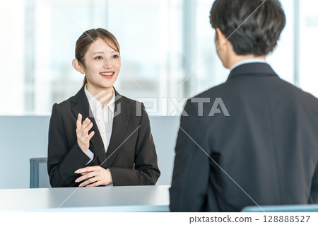 Interviewer, media, female reporter interviewing a man in a suit Interviewer, media, female reporter interviewing a man in a suit 128888527
