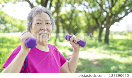 Happy Asian senior woman lifting dumbbell Happy Asian senior woman lifting dumbbell 128890620