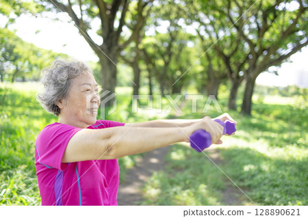 Happy Asian senior woman lifting dumbbell Happy Asian senior woman lifting dumbbell 128890621