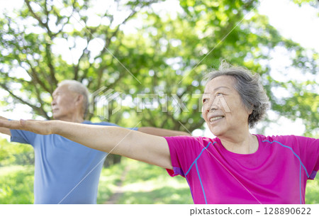 Happy asian senior couple exercising in the park. 128890622