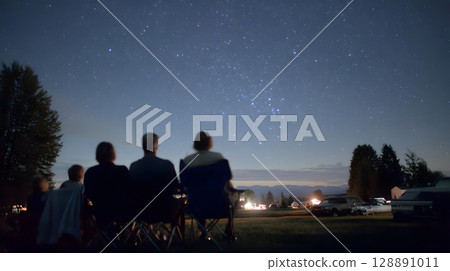 Family stargazing on camping trip 128891011