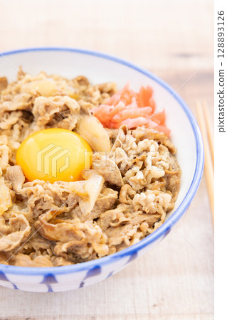 Delicious beef bowl topped with pickled ginger and raw egg 128893126