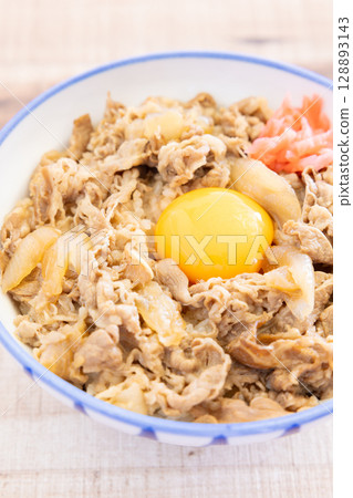 Delicious beef bowl topped with pickled ginger and raw egg 128893143