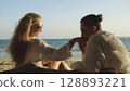 Loving couple in white dress, sunglasses, kissing, relax and dri Loving couple in white dress, sunglasses, kissing, relax and dri 128893221