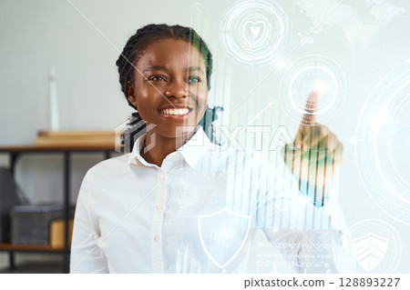 Smiling Professional Interacting With Virtual Interface in Modern Office Environment Smiling Professional Interacting With Virtual Interface in Modern Office Environment 128893227
