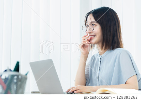 Woman using a laptop Woman using a laptop 128893262