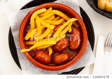 Traditional Spanish roasted chorizo sausages stewed in apple cider Traditional Spanish roasted chorizo sausages stewed in apple cider 128893276